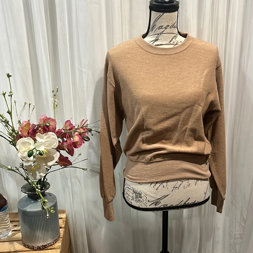 The sweater is a small from the brand reflex, in a tan/brown color. Never worn.